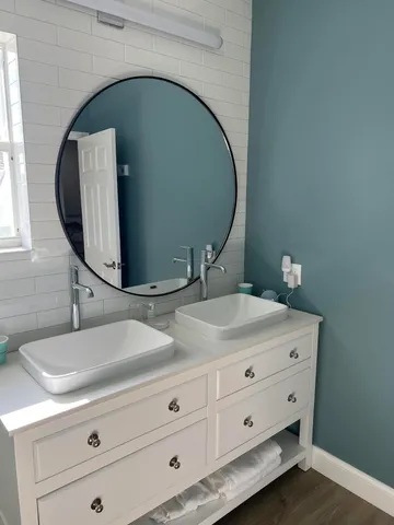 a bathroom with a sink and mirror