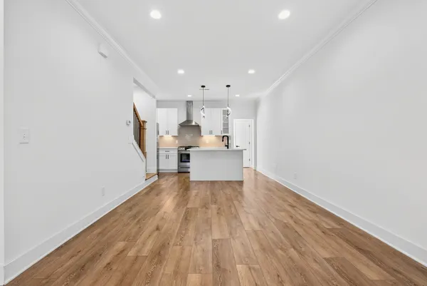 a view of kitchen with wooden floor and electronic appliances