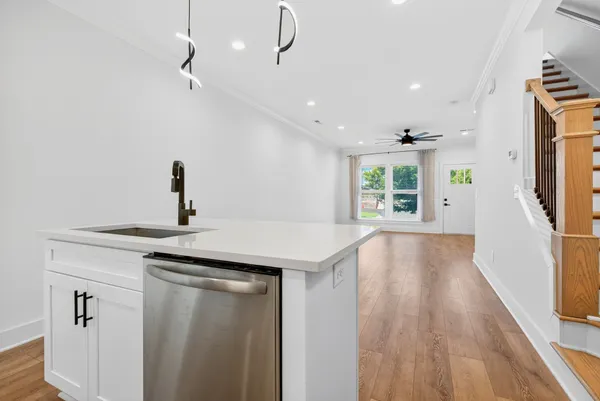 a kitchen with a sink a refrigerator and window