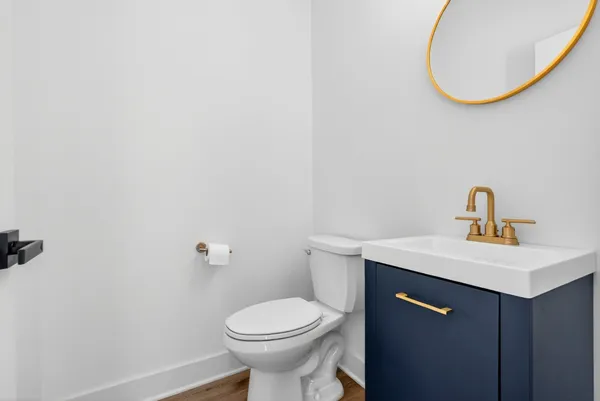 a bathroom with a sink a toilet and a mirror