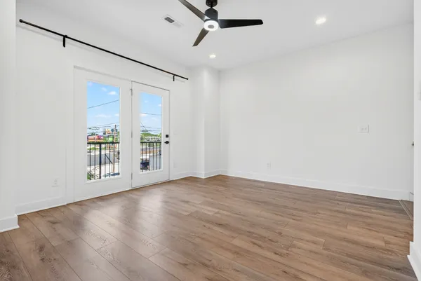 wooden floor in an empty room with a window