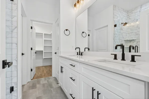 a spacious bathroom with double vanity sink and a mirror