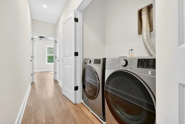 a view of washer and dryer with kitchen in the background