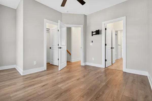 a view of an empty room and wooden floor