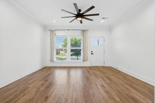 wooden floor in an empty room with a window