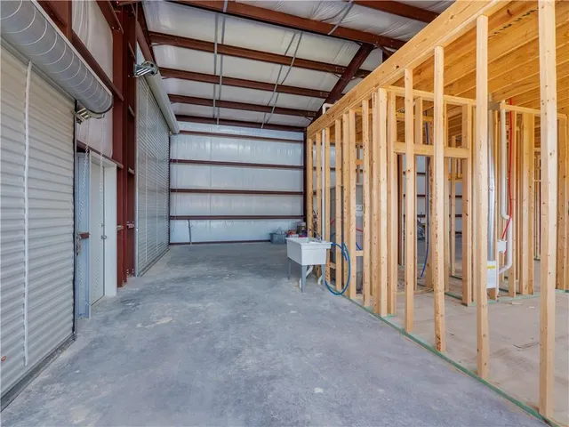 a street with trees and a building in the background