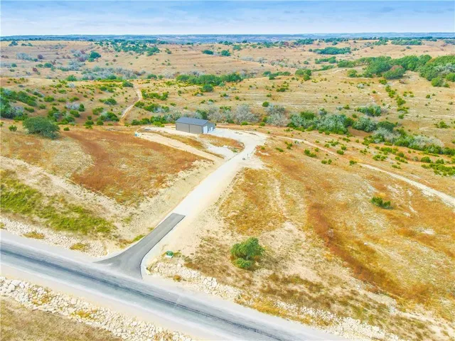 a front view of house with yard seating and city in the background
