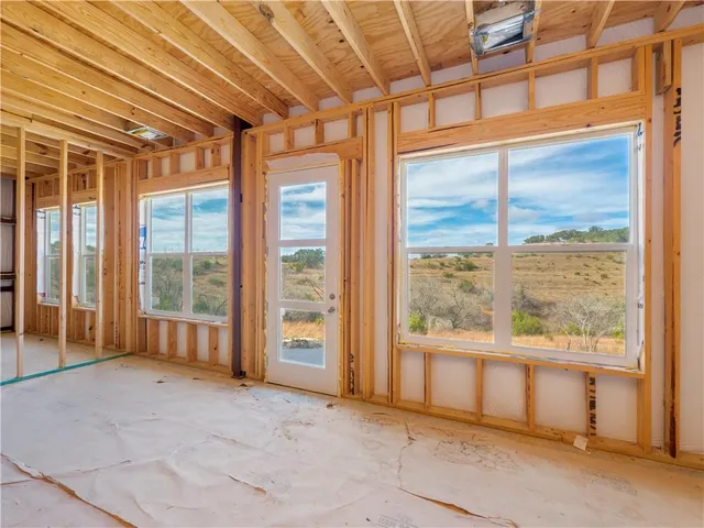 a view of an empty room with glass door