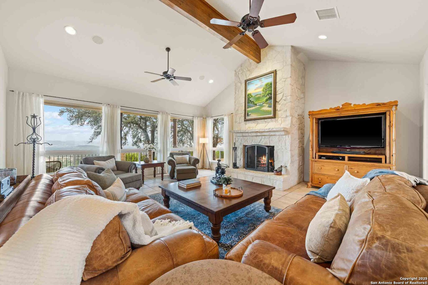211 Mill Dam Road Comfort, TX 78013 - Photo 15 of 61 a living room with furniture a flat screen tv and a fireplace