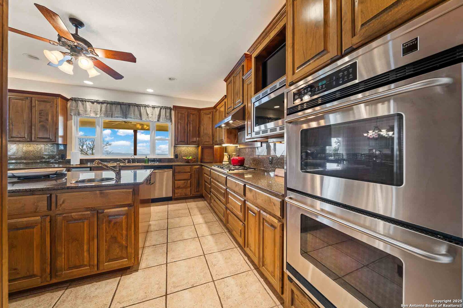 211 Mill Dam Road Comfort, TX 78013 - Photo 20 of 61 a kitchen with stainless steel appliances granite countertop a stove and a sink