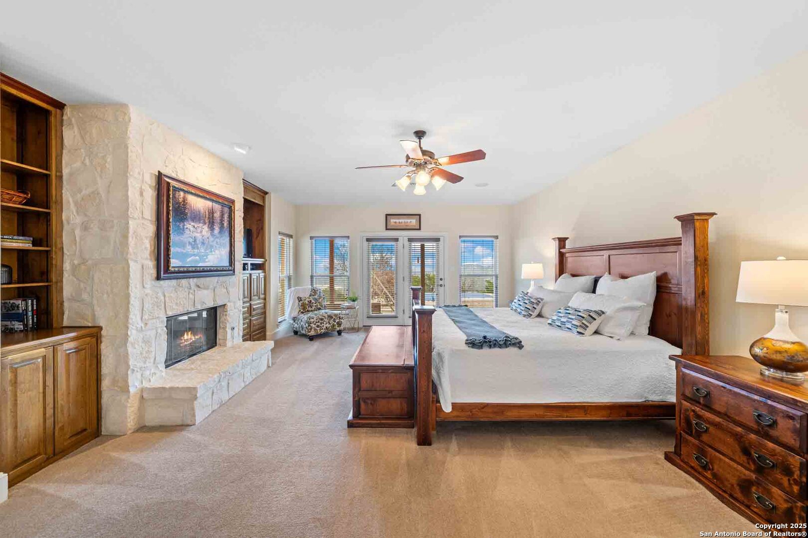 211 Mill Dam Road Comfort, TX 78013 - Photo 22 of 61 a spacious bedroom with a bed a couch and a chandelier