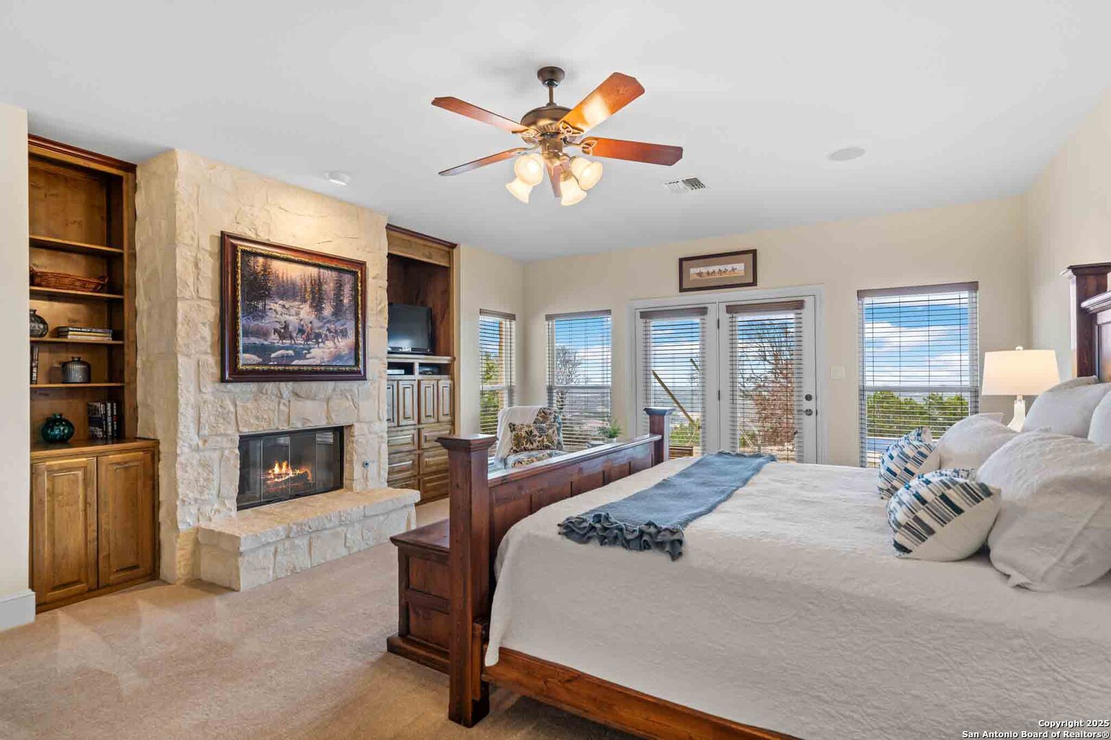 211 Mill Dam Road Comfort, TX 78013 - Photo 23 of 61 a bedroom with a large bed a fireplace and a window