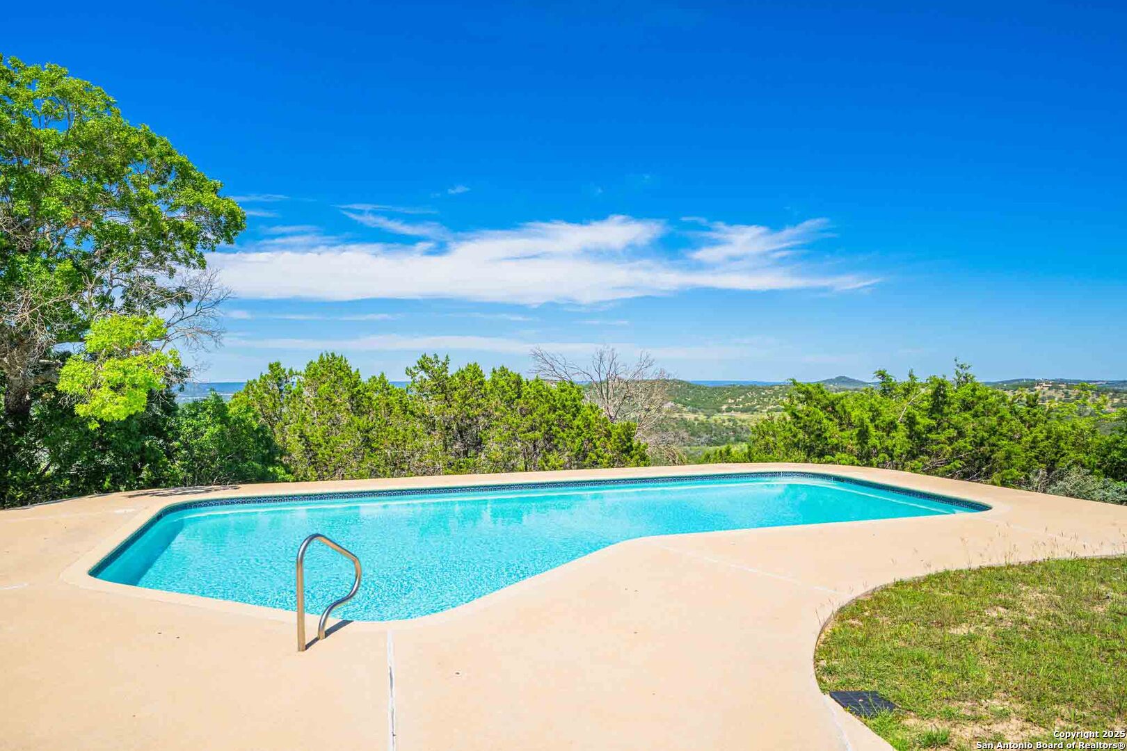 211 Mill Dam Road Comfort, TX 78013 - Photo 41 of 61 a view of a swimming pool with a yard and large trees