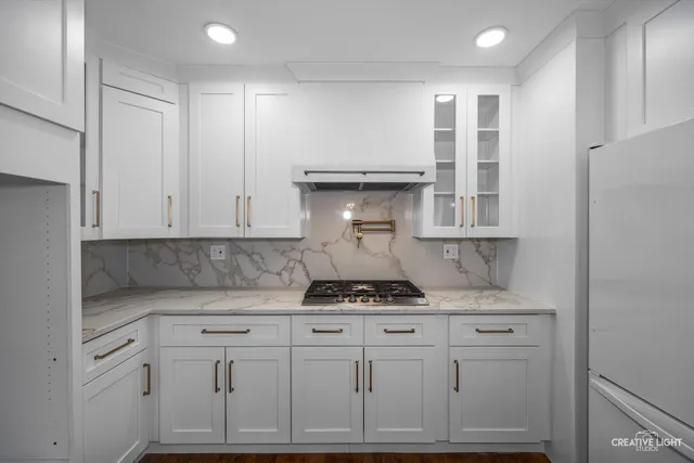 a view of a kitchen counter space a sink and appliances