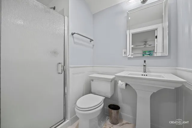 a spacious bedroom with a bed and a lamp