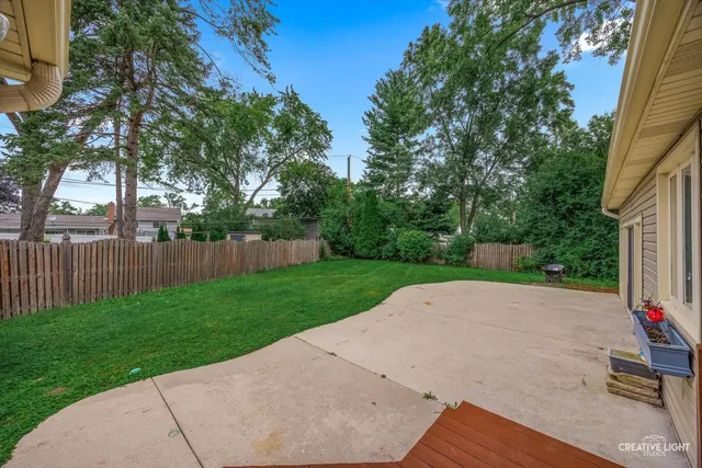 an aerial view of a house with a yard table and chairs