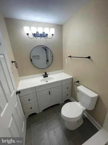 a bathroom with a toilet a sink and a mirror