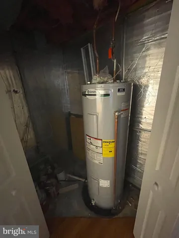 a room with water heater refrigerator washer and dryer