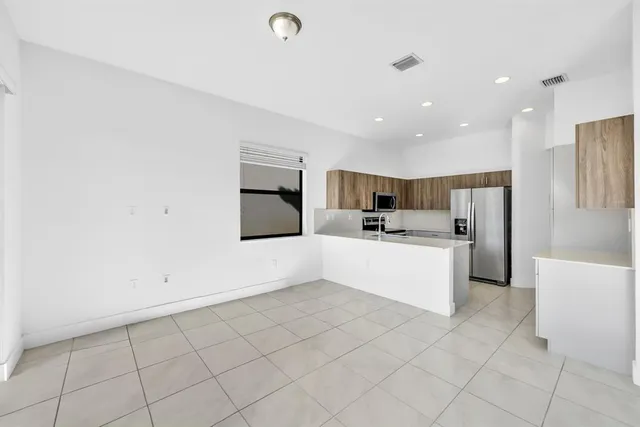 a large white kitchen with a large window