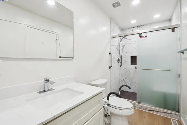 a bathroom with a sink toilet and shower