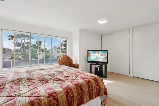 a bed sitting in a bedroom next to a window