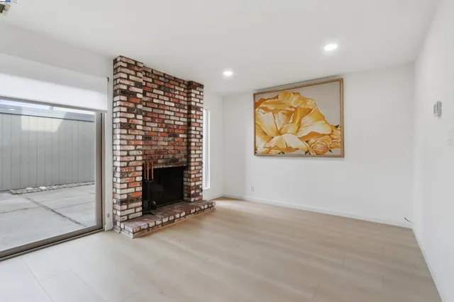 a view of an empty room with a fireplace