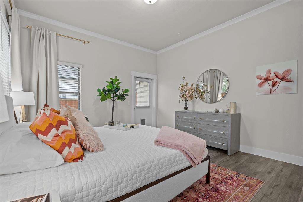 3275 Ganzer Road West, Unit 110A Denton, TX 76207 - Photo 21 of 25 a bedroom with bed and wooden floor