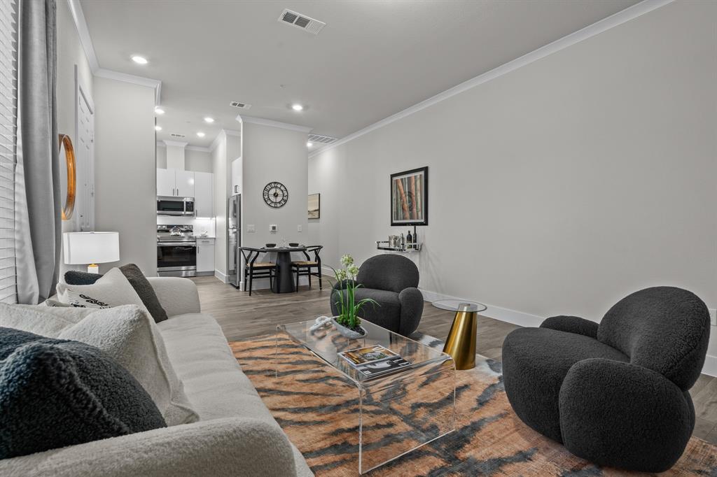 3275 Ganzer Road West, Unit 110A Denton, TX 76207 - Photo 6 of 25 a living room with furniture rug and wooden floor