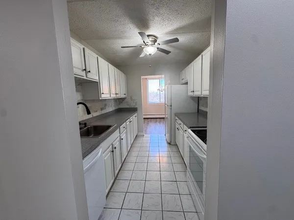 a large kitchen with cabinets and stainless steel appliances