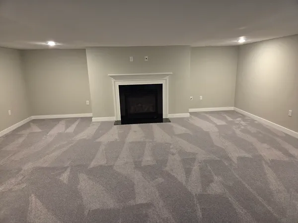 a view of empty room with a fireplace