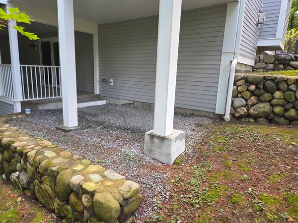 a view of a wooden house with a yard