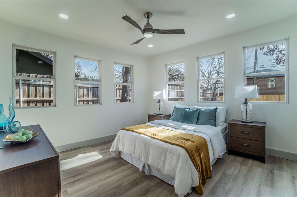 5914 Victor Street Dallas, TX 75214 - Photo 12 of 32 a bed room with a bed window and a table