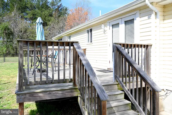a view of balcony with wooden floor and fence