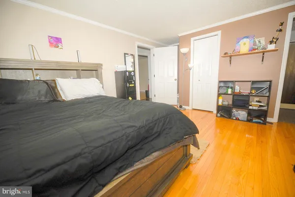 a spacious bedroom with a bed and dresser
