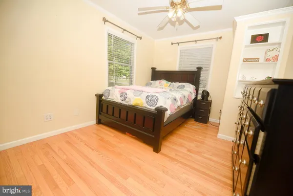 a spacious bedroom with a bed and a chandelier
