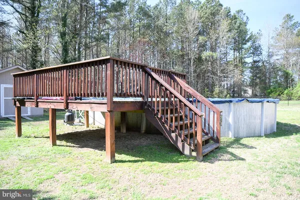 a view of a house with backyard and wooden fence