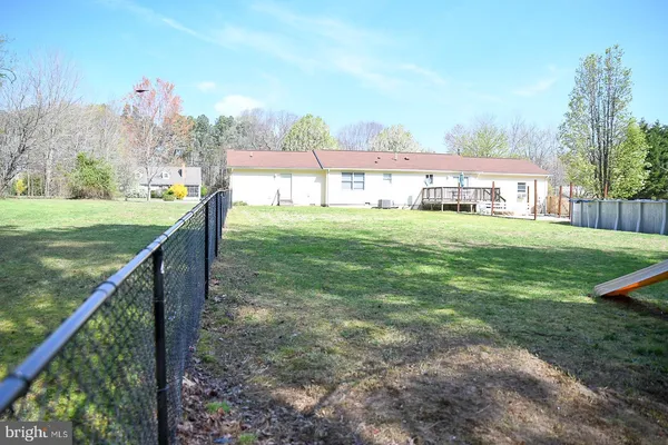 a view of a house with a yard and sitting area
