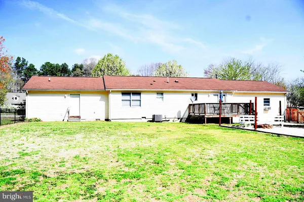 a view of a house with a yard and sitting area