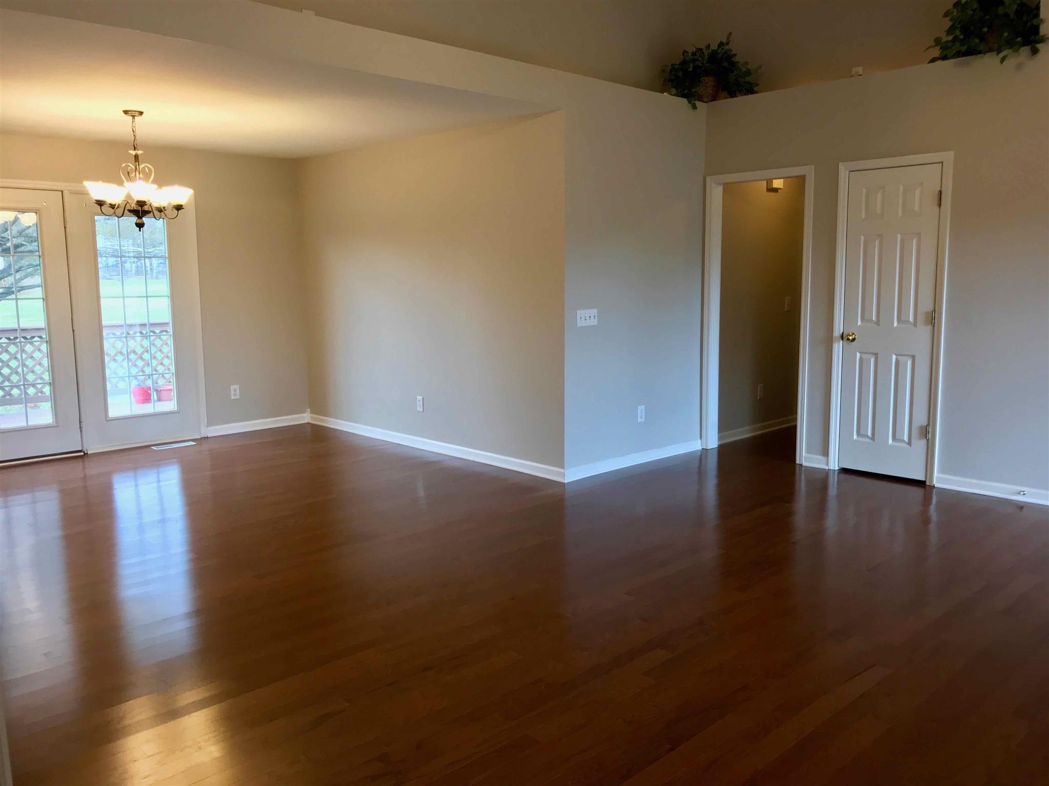 1955 Lasea Road Spring Hill, TN 37174 - Photo 5 of 21 an empty room with wooden floor and windows