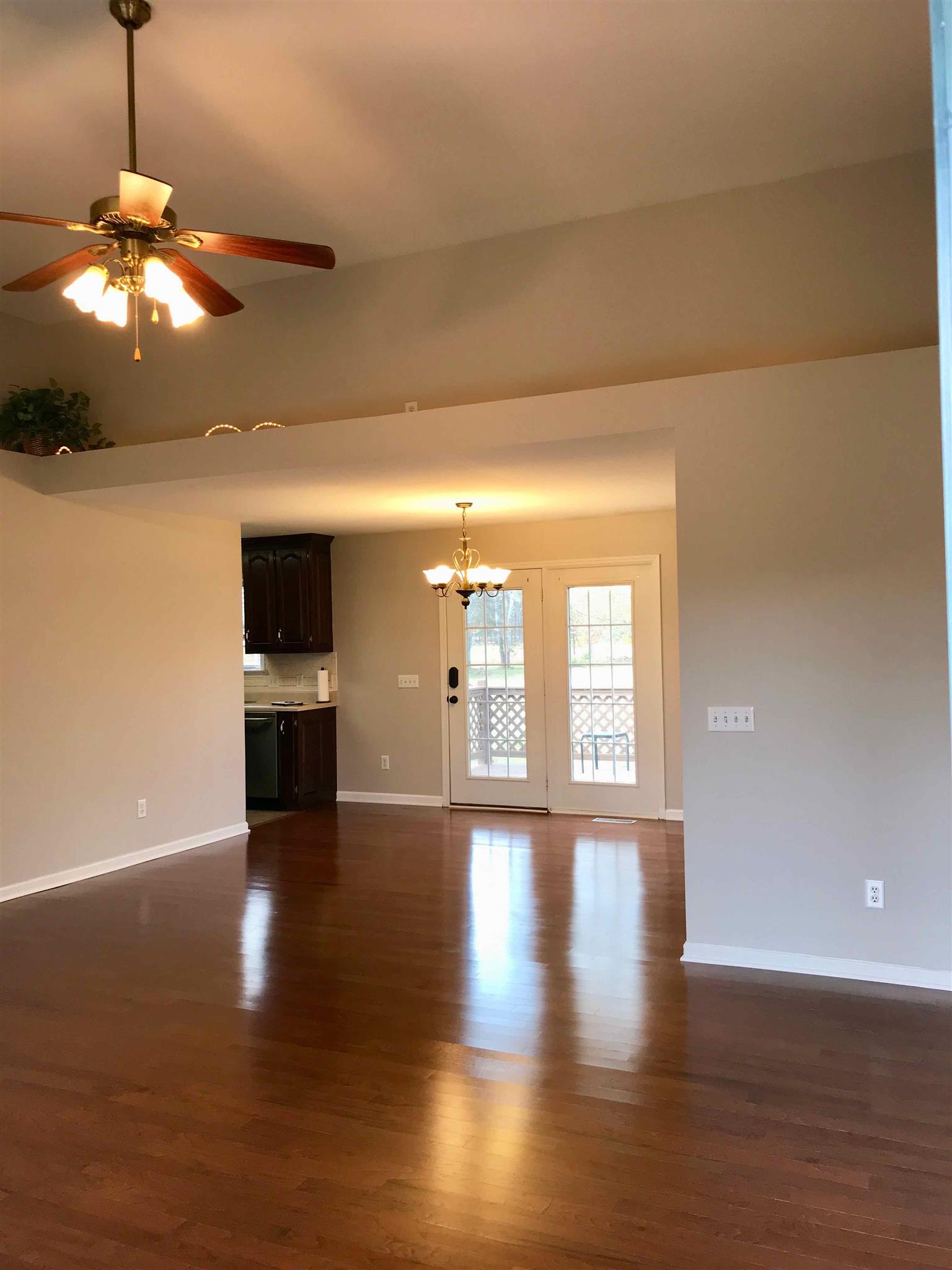 1955 Lasea Road Spring Hill, TN 37174 - Photo 6 of 21 a view of an empty room with wooden floor and a window