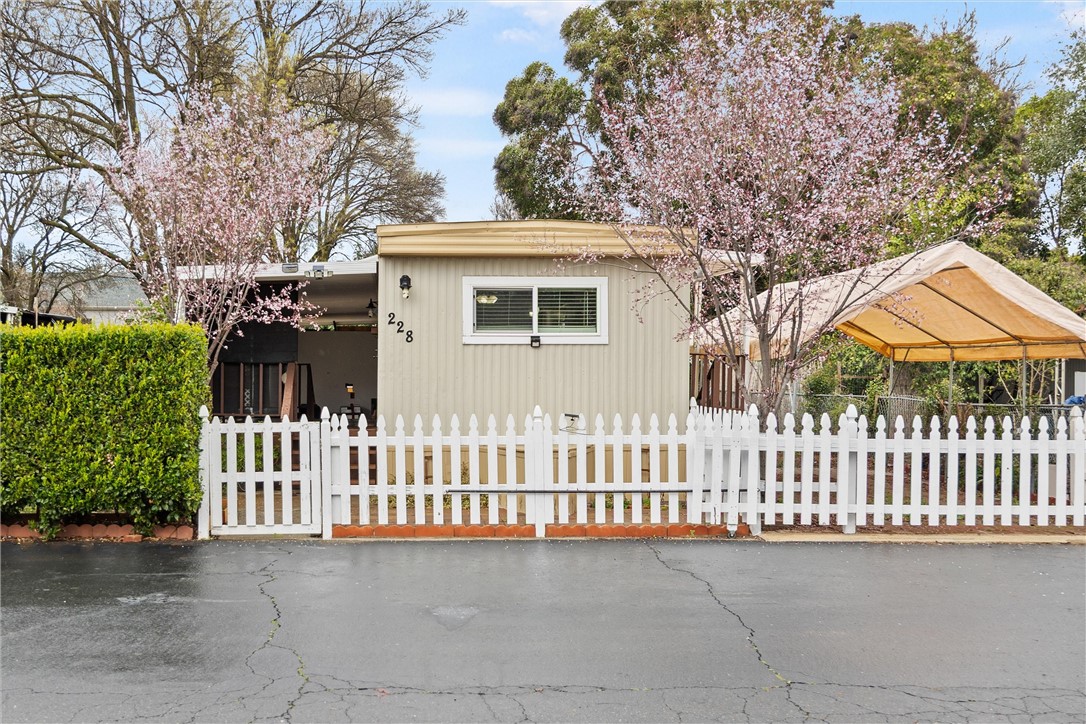 3156 Esplanade, Unit 228 Chico, CA 95973 - Photo 1 of 1 a front view of a house with a garden