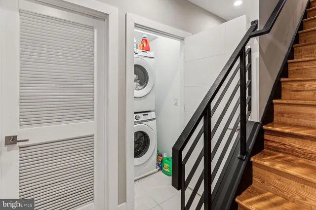 a view of a storage and utility room with washer and dryer