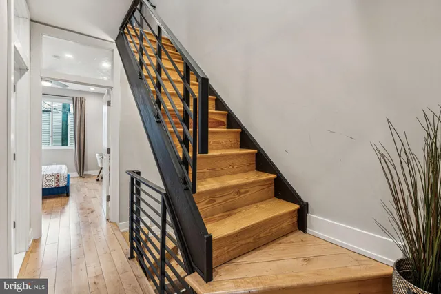 a view of entryway and hall with wooden floor