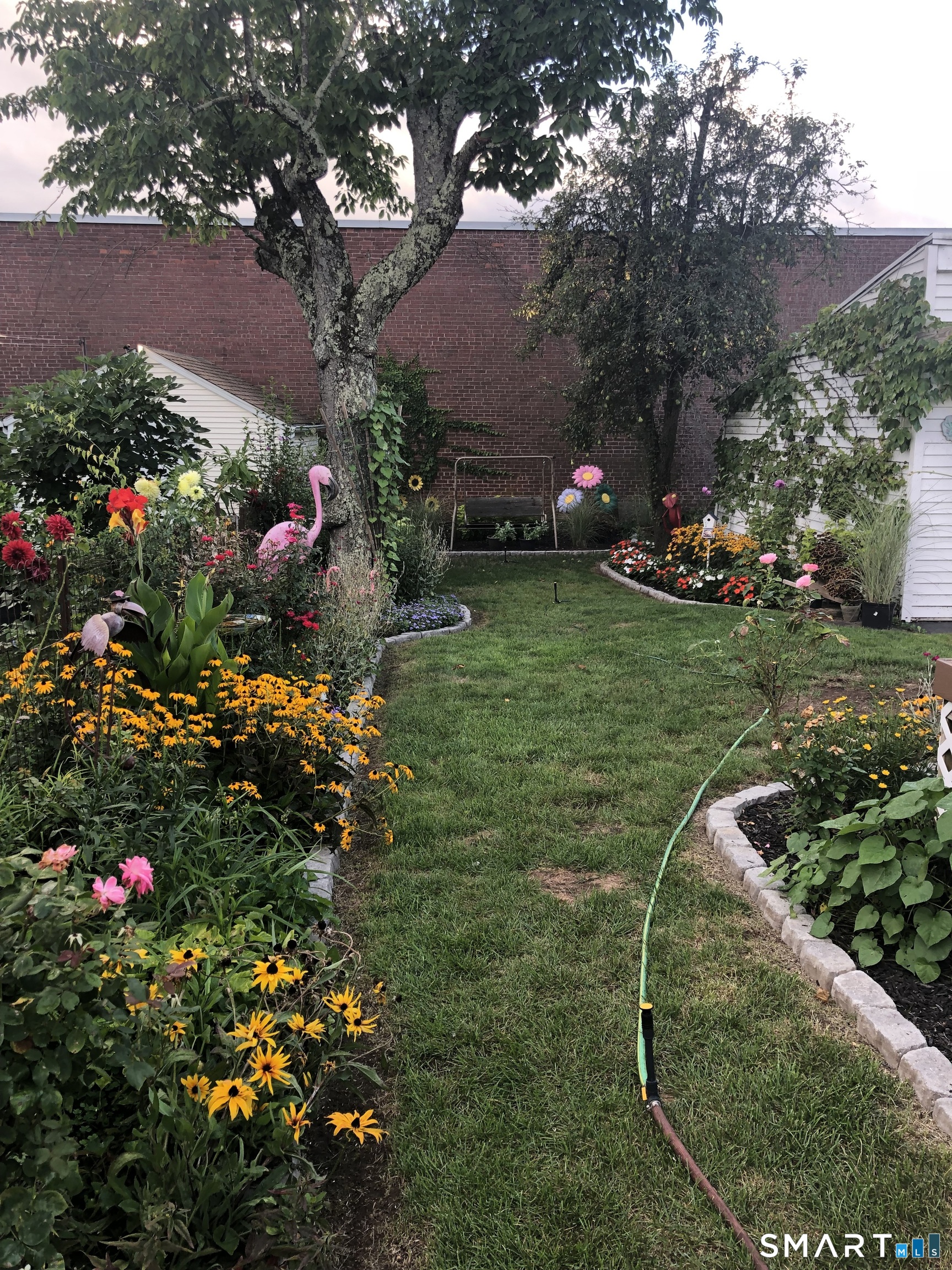 15 Oregon Avenue Hamden, CT 06514 - Photo 12 of 16 a view of a wooden house with a yard and potted plants