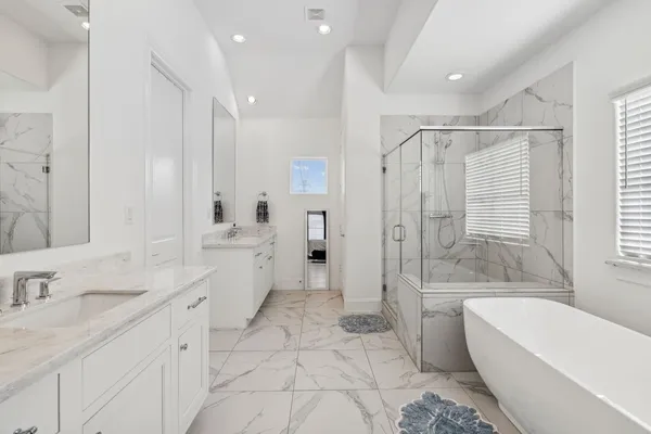 a bathroom with a granite countertop sink a toilet a tub and shower