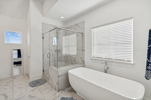 a bathroom with a bathtub and a shower