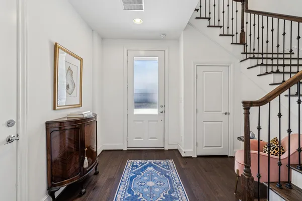 a view of an entryway with wooden floor