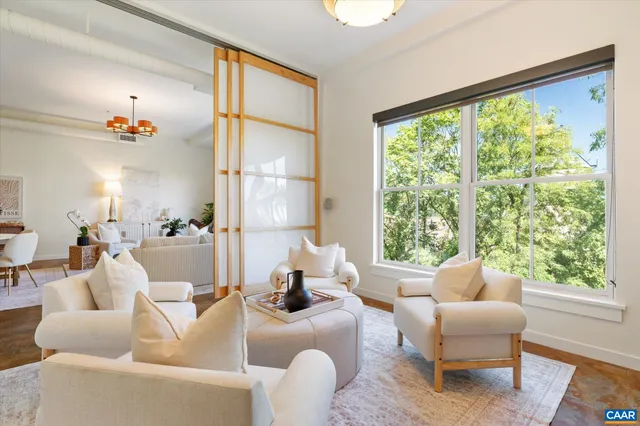 a living room with furniture and a large window