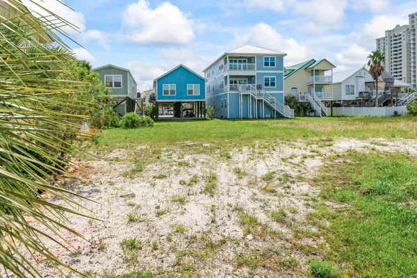 a front view of a residential houses with yard