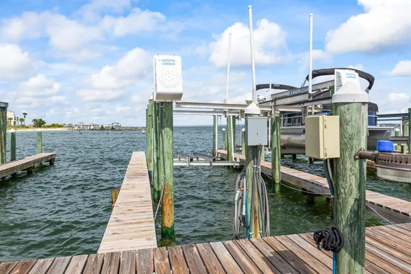 a view of a balcony with dining table & chairs